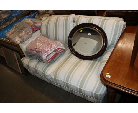 A green striped upholstered two seat sofa