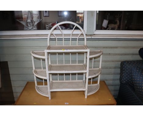 A bamboo and wicker shelf unit