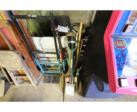 A quantity of various tools to include digging spades, loppers, bow saw, pick axe etc