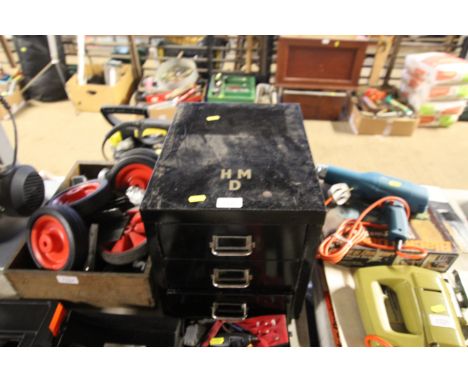 A metal three drawer filing chest with contents of various tools to include small bench vice, spanners, three leather cased t