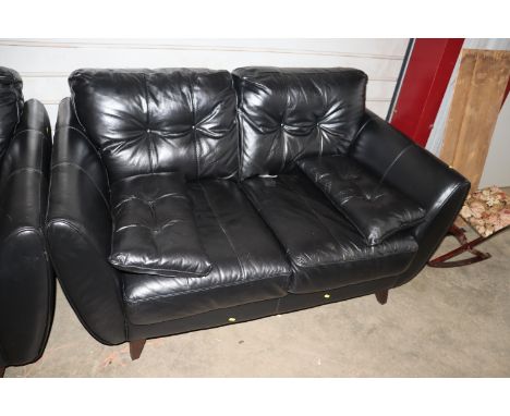 A black leatherette button two seat sofa