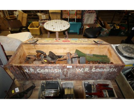 A wooden carpenters tools chest and contents containing two large smoothing planes, combination plane, moulding planes, and b