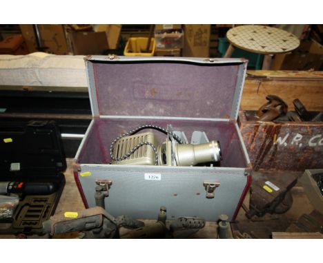 An Aldis slide projector in travel case with portable projector screen in case 