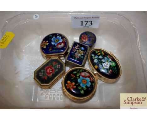 A collection of six various floral enamel decorated pill boxes 