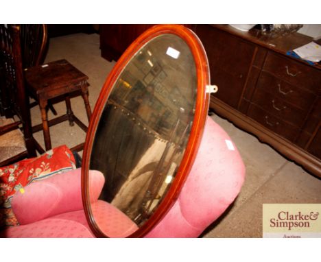 An Edwardian oval bevel edged wall mirror 