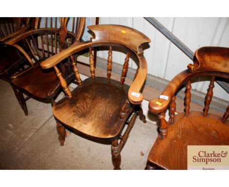 A Victorian elm seated smokers bow elbow chair 