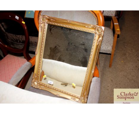 A gilt framed wall mirror