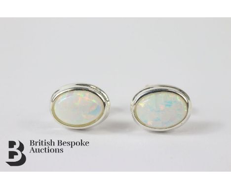 Pair of silver and opal stud earrings.