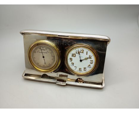 An Art Deco engine turned silver cased travel clock and barometer, with engraved initials and dated 8.6.25, hallmarked London