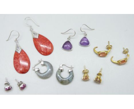 Six pairs of silver earrings set with semi-precious stones including amethyst, sunstone, labradorite, coral and ruby