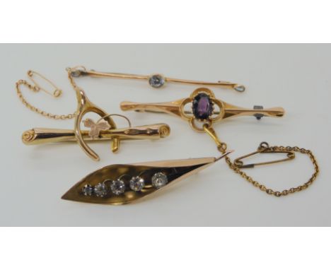 Four 9ct gold brooches aquamarine, wishbone, lily of the valley and one set with amethyst, weight combined 8gms Condition Rep