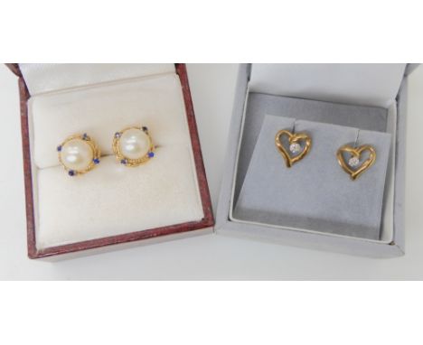 A pair of 9ct gold pearl and sapphire earrings, together with a pair of 9ct diamond accent heart shaped earrings, weight toge