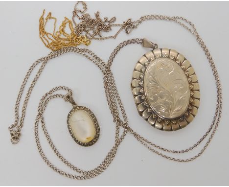A large silver locket hallmarked Birmingham 1973, a mother of pearl pendant and other items Condition Report: Not available f