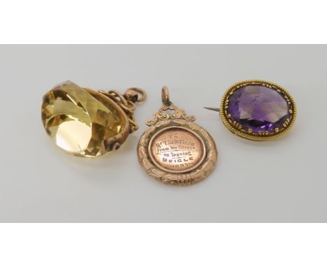 A 9ct gold citrine fob seal, a bright yellow metal ametrine brooch and a yellow metal medallion, weight combined 24.1gms Cond