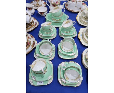 A Royal Paragon Waterlily pattern teaset comprising twelve cups, saucers and plates, cake plate, oval dish, milk jug and suga