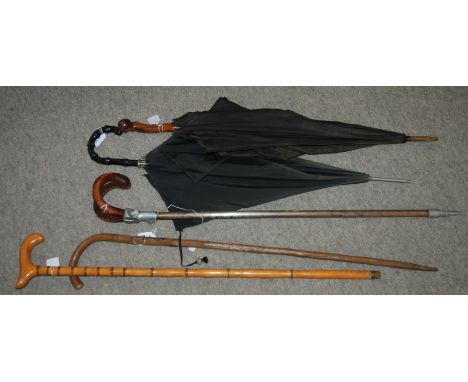 A shooting stick, two umbrellas and two walking canes Condition Report: Available upon request