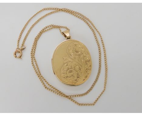 A 9ct gold engraved oval locket and chain, locket approx 4.5cm x 2.7cm including bail, chain length 51cm, weight 17.3gms Cond