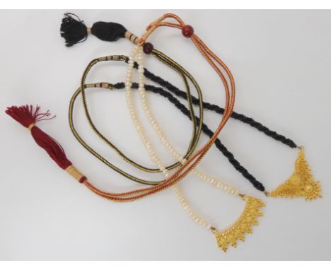 Two bright yellow metal pendants both stamped 22c, with decorative pearl and bead tassel necklace weight approx of the pendan