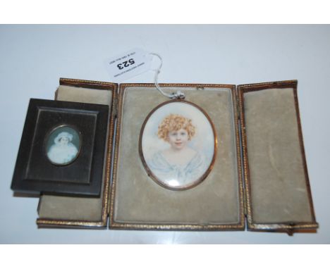 A painted portrait miniature of a child signed RMK, in gilt-metal frame, 7 x 6cm in leather fitted case with easel stand and 