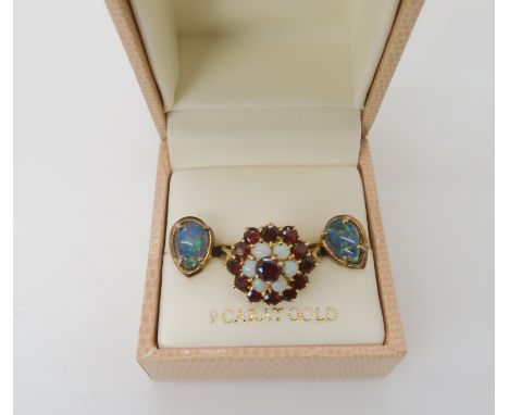 A 9ct gold garnet and opal cluster ring, size P, weight 4.3gms and a pair of gold plated opal triplet earrings Condition Repo