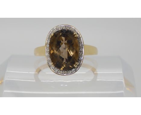 A 9ct gold smoky quartz and diamond ring size W, weight 4.4gms Condition Report: Available upon request