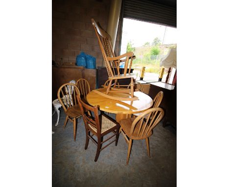 Elm table and a rocking chair, a rush seated chair and 4 elm seated stick back chairs