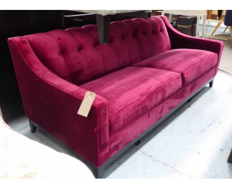 SOFA, with slope arms and button back, upholstered in Zoffany red velvet, with dark stained wooden plinth, 210cm W x 90cm D x