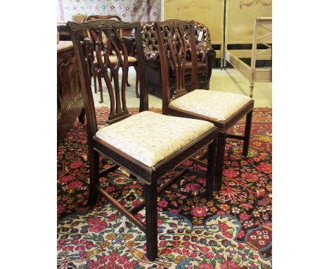 DINING CHAIRS, set of six, Georgian mahogany in the Chippendale manner, each with an ornate pierced splat back and a foliate 