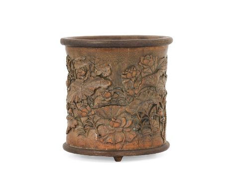 A Chinese Bamboo Brush Pot, Qing Dynasty, with hardwood rim and base, carved in relief with a continual lily pond and ducks, 