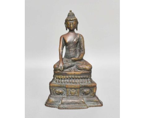 A Sino-Tibetan Bronze Figure of a Seated Buddha, on lotus throne over a stepped breakfront plinth, 25cmNo breaaks or losses. 