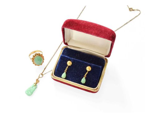 A Jade Ring, the oval cabochon jade in a yellow rubbed over setting, to a scroll surround, stamped '18K', finger size M1/2; A