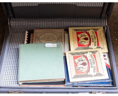 An Album of Ogden Guinea Gold Cigarette Cards, a quantity of Willis and other cigarette cards and postcards in a briefcase