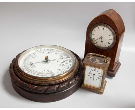 An Oak Cased Aneroid Barometer, circa 1900, together with an inlaid mahogany mantel timepiece, and a French brass cased carri