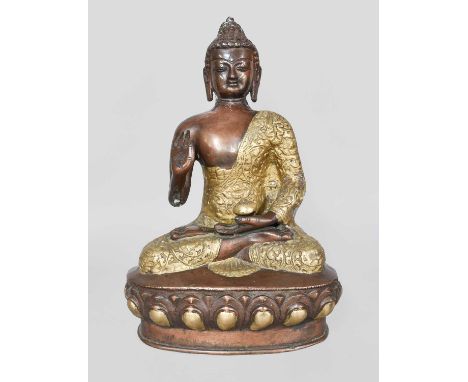A Parcel Gilt Bronze Tibetan Style Devotional Statue of Buddha, raised on lotus plinth, 30cm