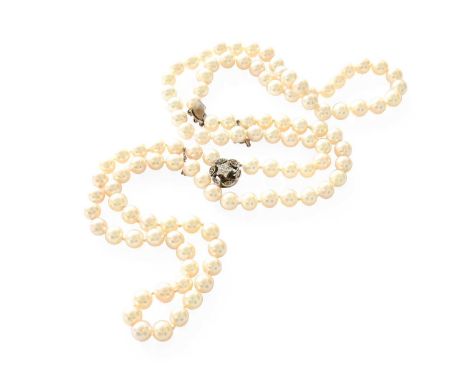 A Two Row Cultured Pearl Necklace, with a diamond cluster clasp, stamped '9CT', length 43cmThe necklace is in good condition,