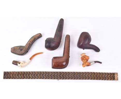 Two Meerschaum pipes, one carved into a dragons claw and the other in the form of a man in Turban, with two further pipe case