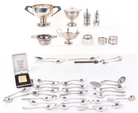 A mixed lot of silver items including a three Victorian dessert spoons, a set of ten tea spoons, Sheffield 1918, a silver tea