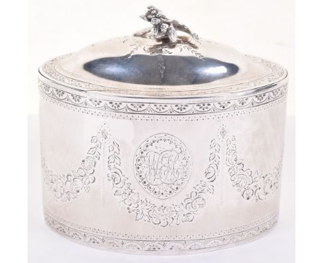 A superb George III silver tea caddy, 1786, by Hester Bateman, hinged lid with cast flower handle, the oval body with border 