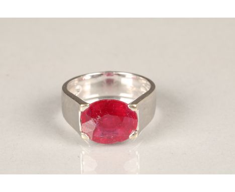 18ct white gold ruby ring, reversible ring which is set with a small cabochon emerald on the underside of the shank. Oval cut