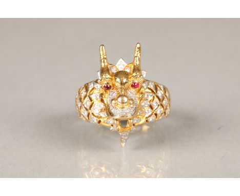 Handcrafted dragon ring, set with approximately 63 diamond chips. Dragon's head projects from the shank and is set with two c