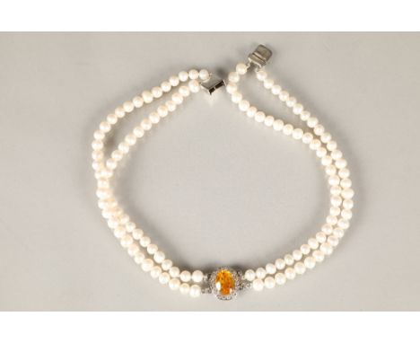 Ladies double strand cultured pearl choker, with a central oval citrine surrounded by cubic zirconia, white metal clasp. 35.5