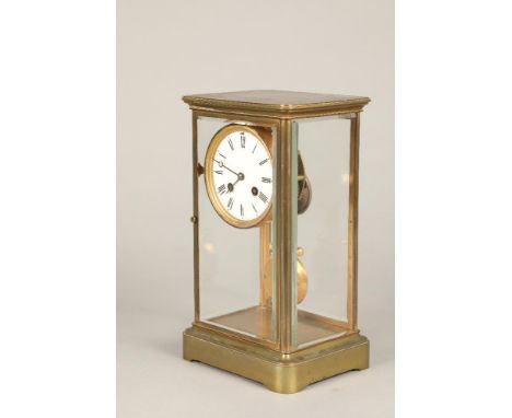 Brass four glass mantle clock, with white enamelled dial with Roman numerals. 30cm high All glass panels are secure and in ve