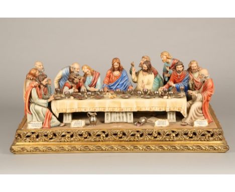 A large Capodimonte ceramic figure group of the last supper on a gilt base. 86cm x 41cm The Jesus plaque is missing but we ha