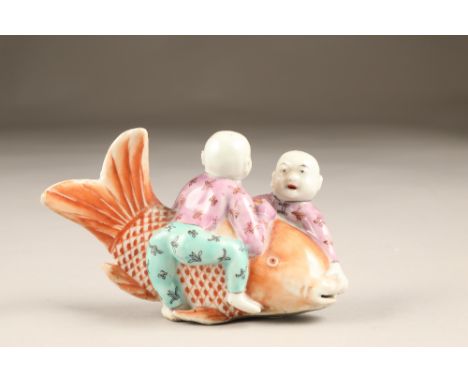 20th century Chinese porcelain figure group of two boys playing with a giant carp. 7cm high The figure group is in excellent 