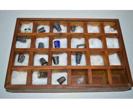 A collection of silver thimbles, some with enamel decoration.