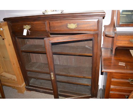 A Victorian walnut bookcase with moulded cornice above two shallow drawers, two glazed panel doors below enclosing adjustable