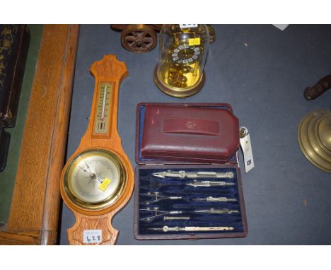 An engineer's revolution counter, in fitted leather case; drawing instruments; a modern clock; and a modern barometer.  (4)