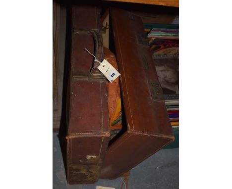A vintage leather case; and a hat box; together with a Samoan paddle.