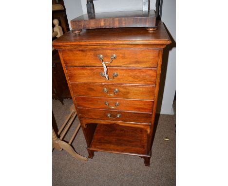 An early 20th Century mahogany music cabinet with five shallow drawers with four fronts and an open shelf below, raised on sh