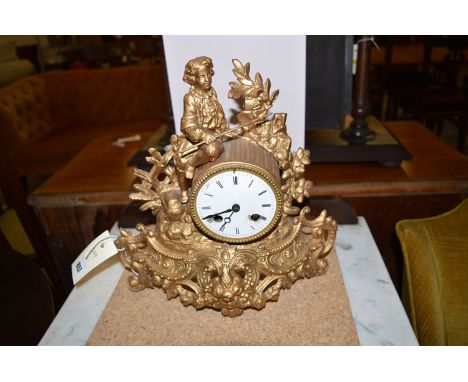 A French 19th Century cast metal mantel clock, the clock in the form of a barrel surmounted by the figure of a child in perio